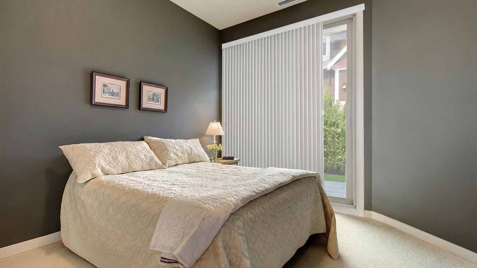 Bedroom with vertical blinds
