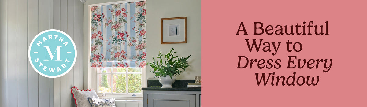 Window seat in a room with Martha Stewart floral roman shades.