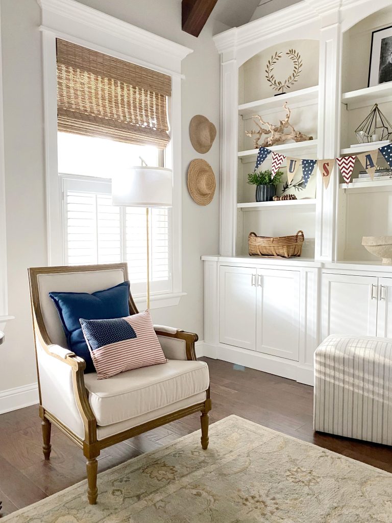 Alicia @ourvintagenest curated this cozy corner window treatment to watch fireworks from with shutters and woven wood blinds