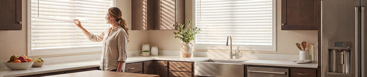 Image of a woman looking through venetian blinds in a kitchen