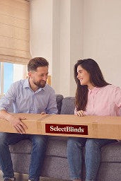 A couple unboxing their SelectBlinds window treatments
